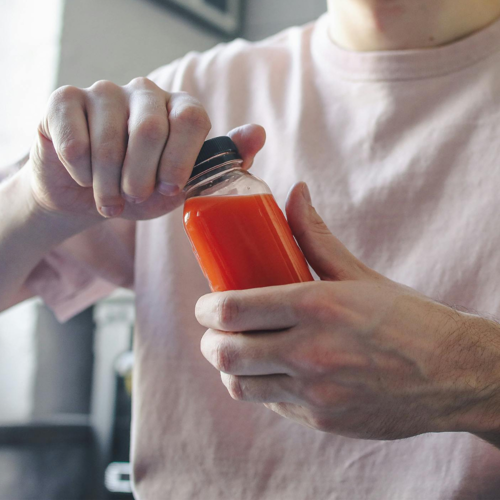 A man opening a bottle of juice