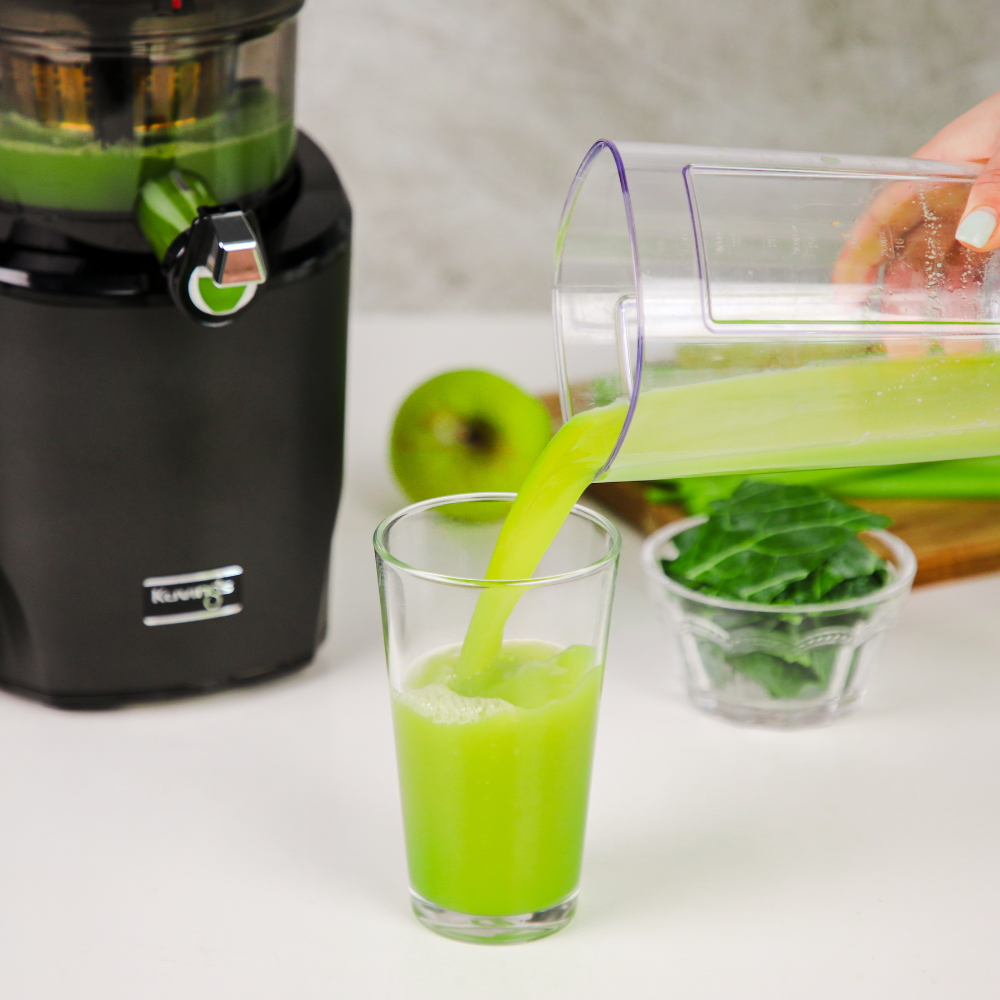 Pouring green juice into a glass