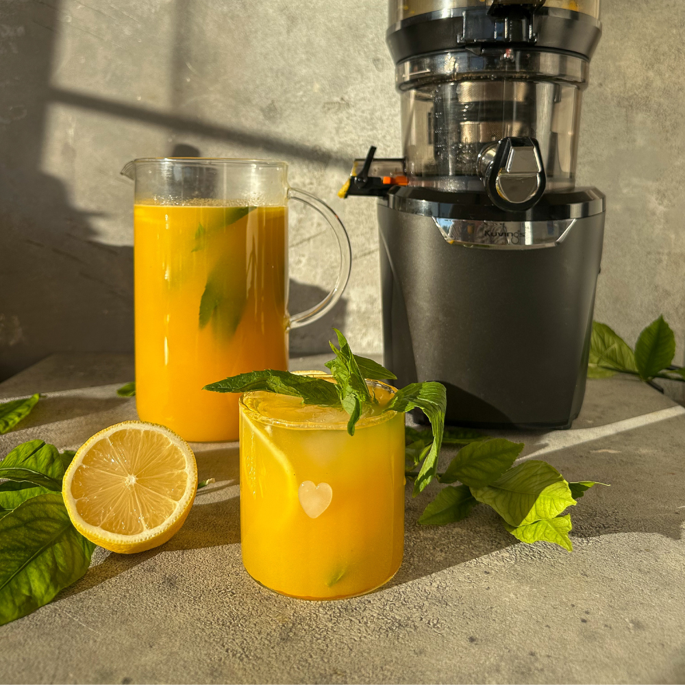 A glass and pitcher of tropical lemonade