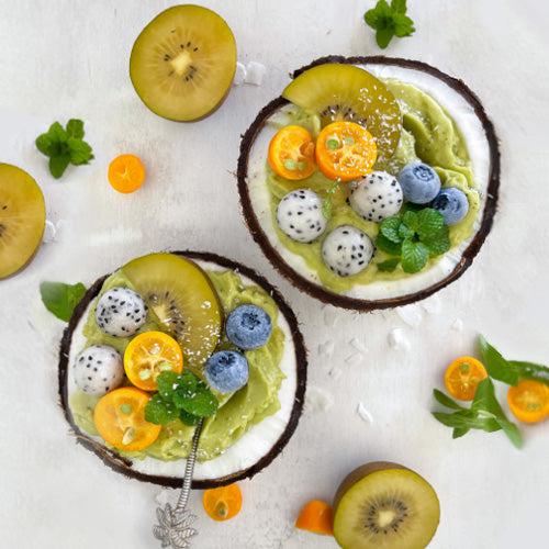 two coconut bowls of avocado banana ice cream