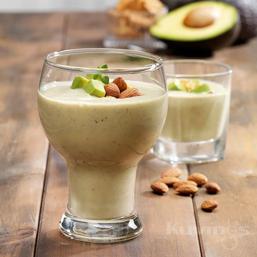 almond butter smoothie in glass with almonds