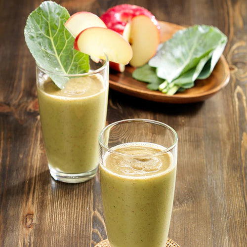 two glasses of apple vegetable juice on wood table