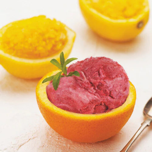 cranberry sorbet scooped in half a hollowed orange