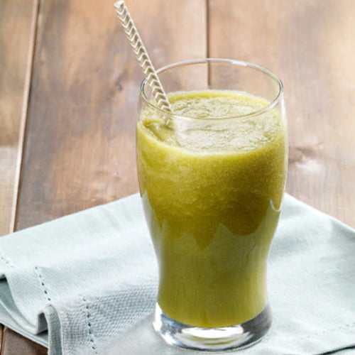 fennel juice in a glass cup on a blue cloth