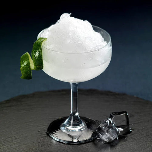 frozen daiquiri in glass with lime rind garnish