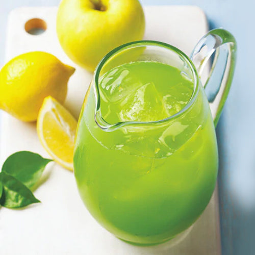 green lemonade in pitcher with apple and lemon