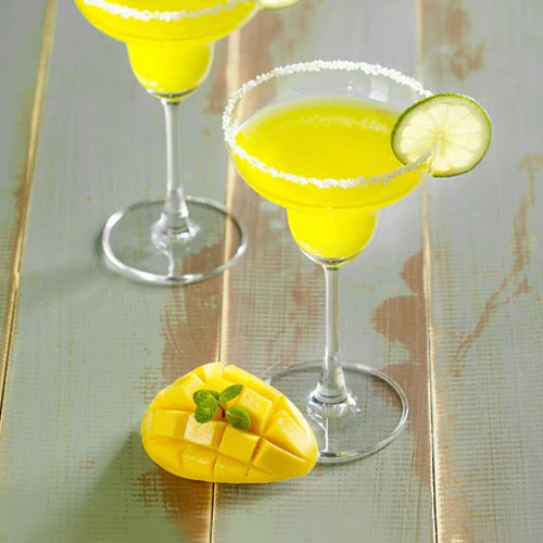 mango margaritas next to sliced mango