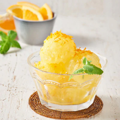 orange lemon sorbet in glass bowl