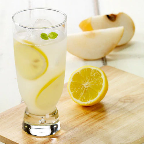 pear lemonade in glass cup with slices of lemon, mint and ice