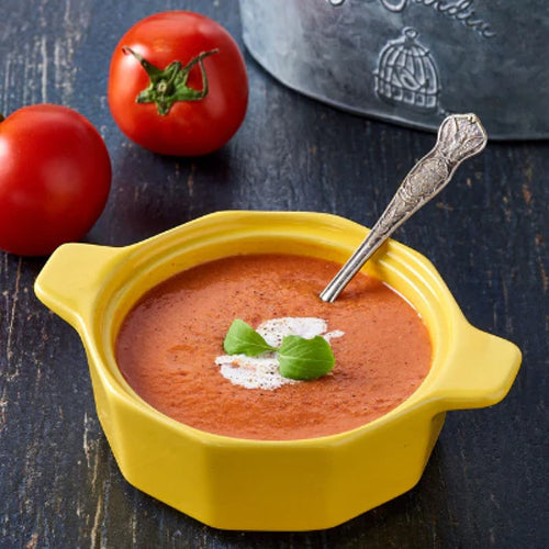 tomato soup in a yellow bowl