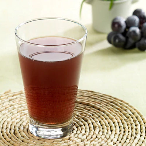 wheatgrass grape juice in glass cup