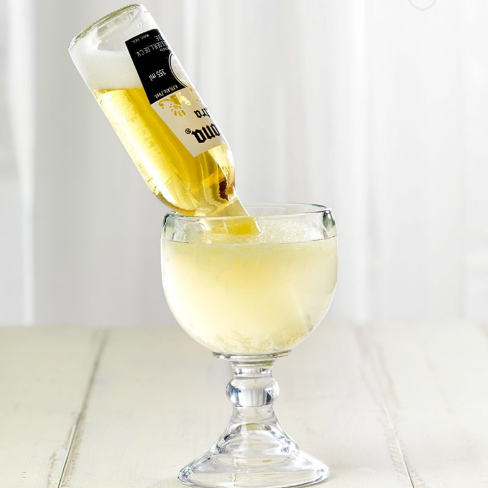 a corona beer bottle in a glass