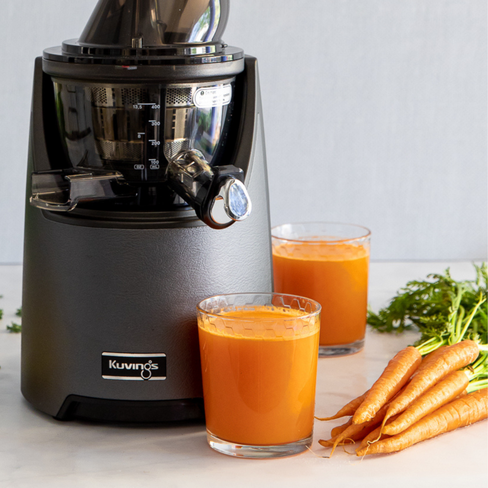 carrot juice next to the kuvings evo820 juicer