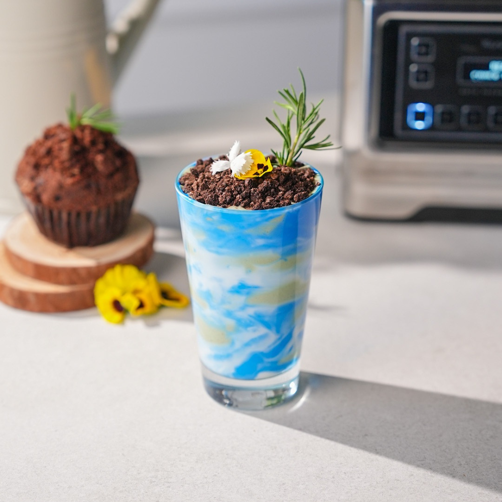 A smoothie in a glass made to look like the Earth