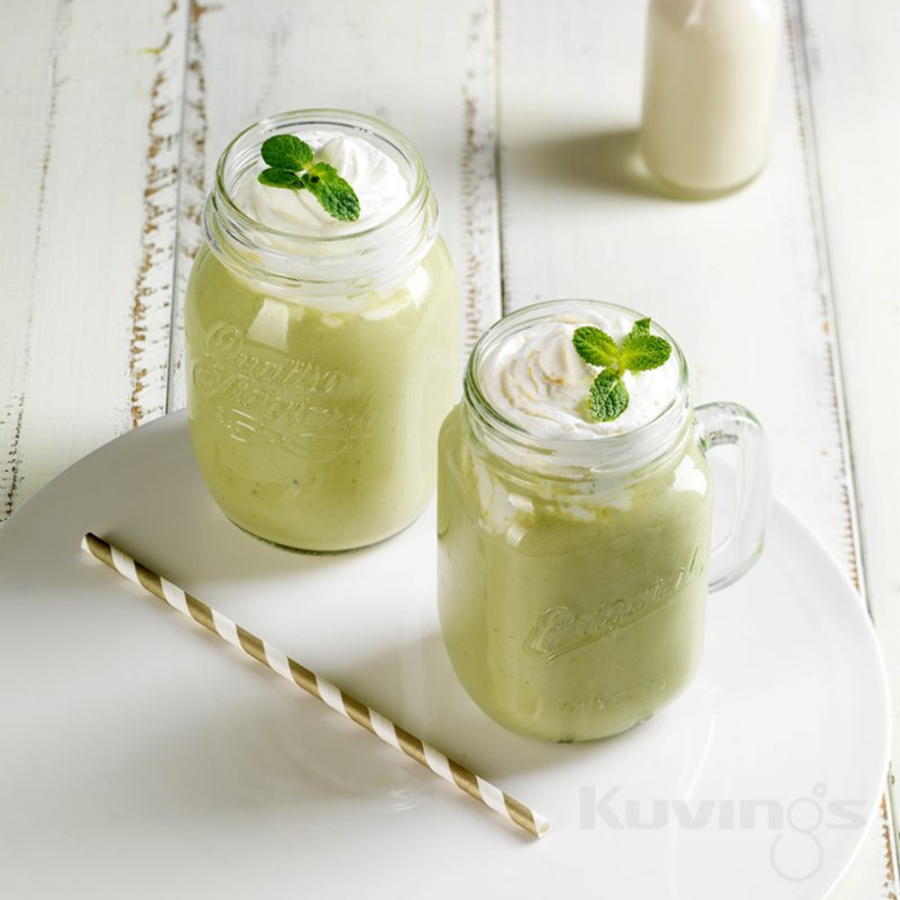 2 green tea smoothies with a straw on a plate