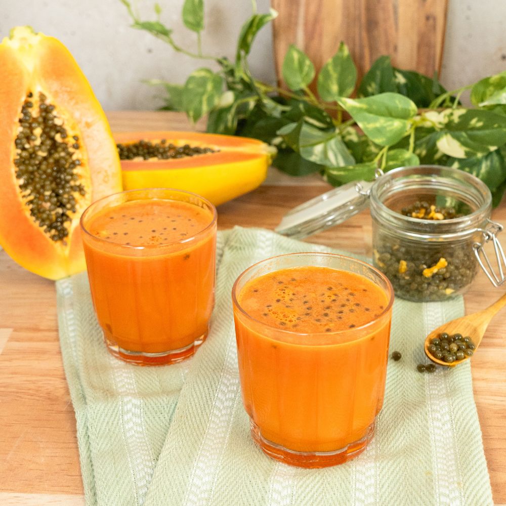 2 glasses of papaya juice with papaya seeds