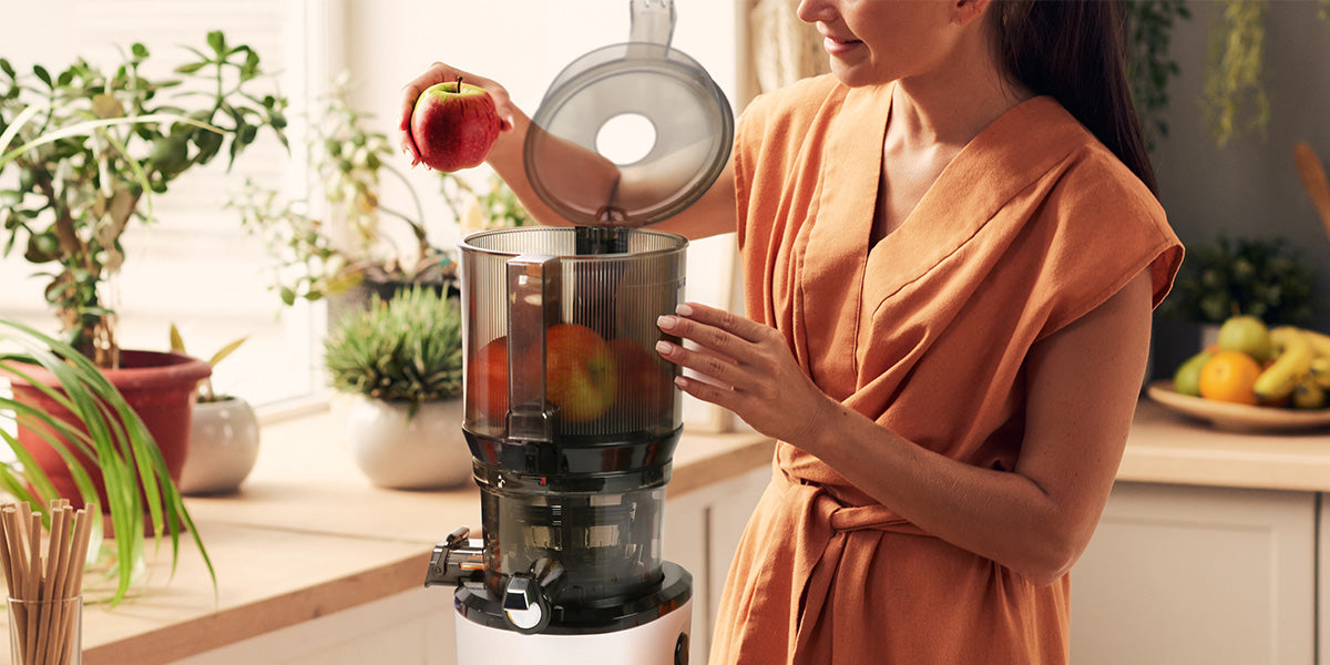 woman juicing apples in auto10 slow juicer