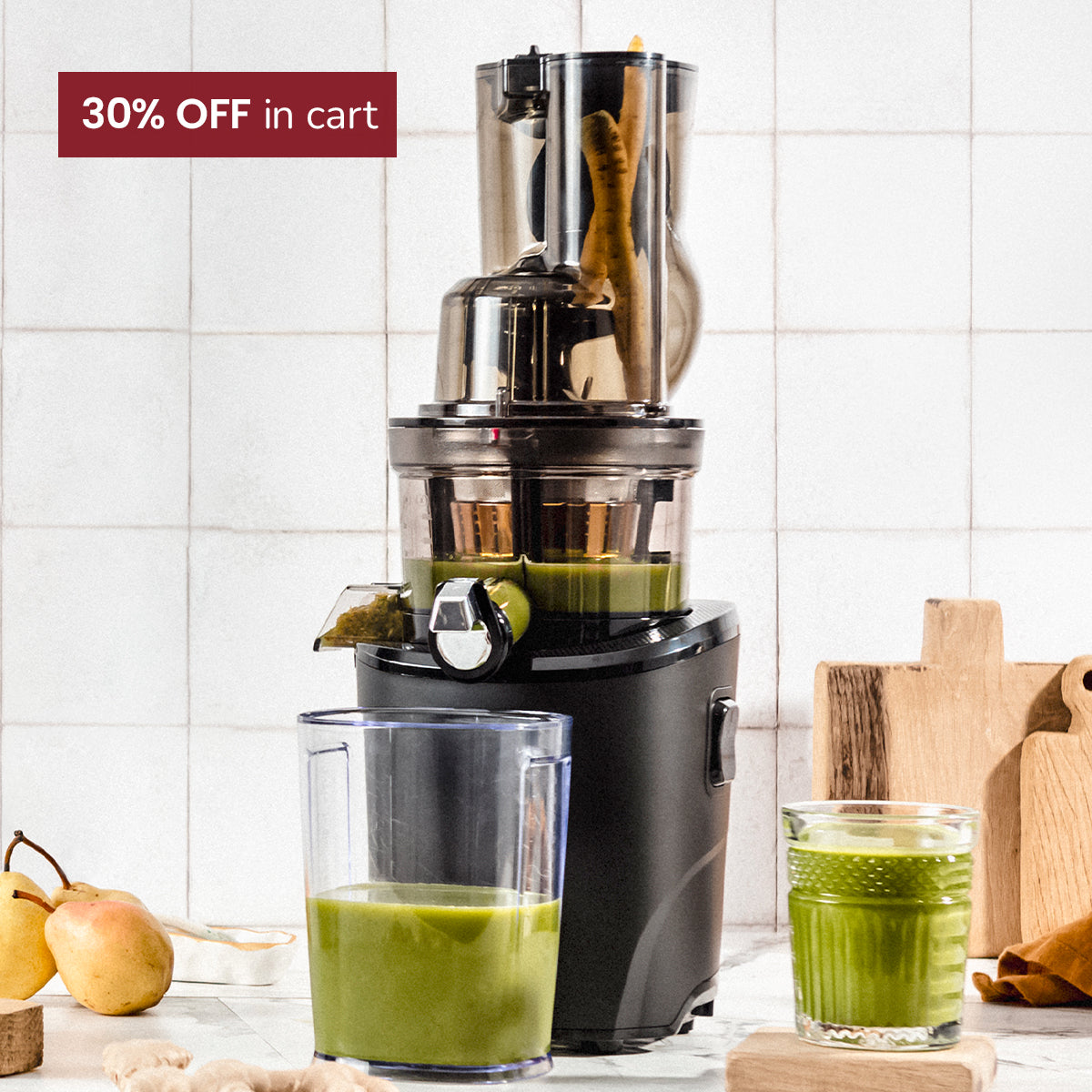 Revo Juicer with green juice  on a kitchen counter.